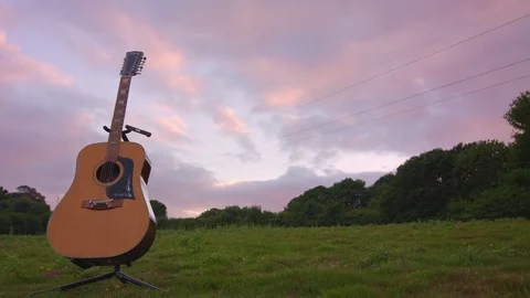 Beautiful Timelapse of sun settting in fields with acoutic guitar Stock Footage 77015604