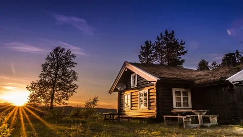 A beautiful timelapse with a sunset and small house. Video stock 94445142
