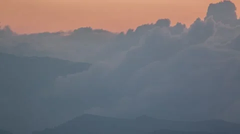 Beautiful Timelapse of Sunset Behind Clouds Passing Over the Mountains Stock Footage 67988017