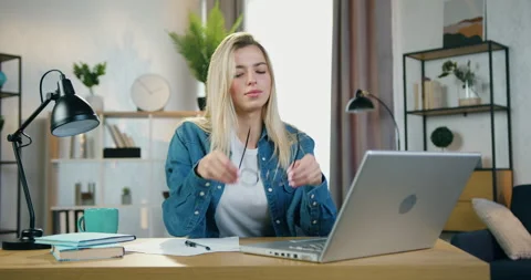 Beautiful tired blond hardworking young woman typing on computer,then taking off Stock Footage 158474432