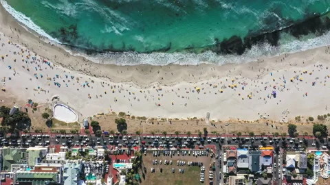 Beautiful top down look Camps Bay beach and the very busy main street down below Stock Footage 170724820