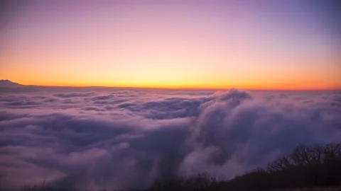 A beautiful top view of the moving clouds. Sunset over the fog Stock Footage