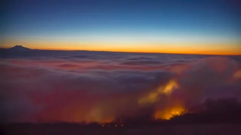 A beautiful top view of the moving clouds. Sunset over the fog Stock Footage 149380314