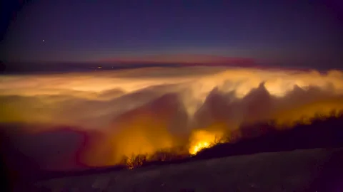 A beautiful top view of the moving clouds. Sunset over the fog Stock Footage 149380409
