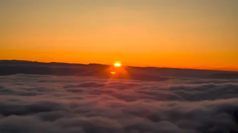 A beautiful top view of the moving clouds. Sunset over the fog Stock Footage 149380487