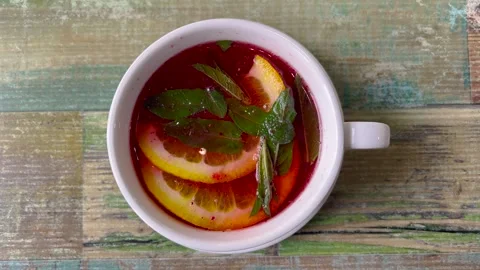 Beautiful top view of a white cup with fruit tea. Red fruit tea, a couple Видео 274189992