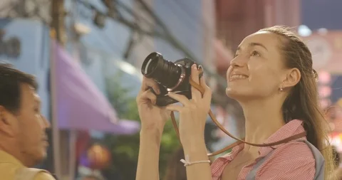 Beautiful tourism backpack women walking in night street market take photo Stock Footage 123720416