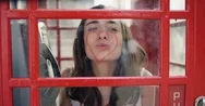 Beautiful Tourist Woman Drawing Heart Shape Red Lipstick On Red Telephone Booth Stock Footage