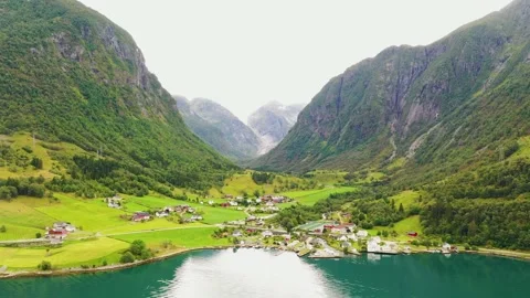 Beautiful Town in a valley between mountains and a lake Stock Footage 166953799