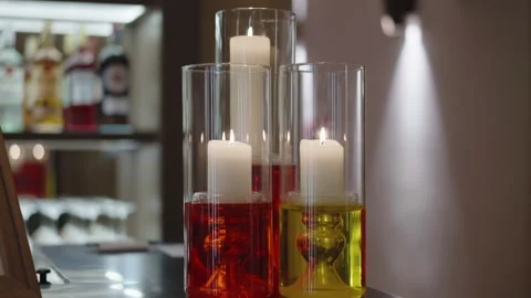 Beautiful transparent vases of different sizes filled with yellow and red Stock Footage 344752941