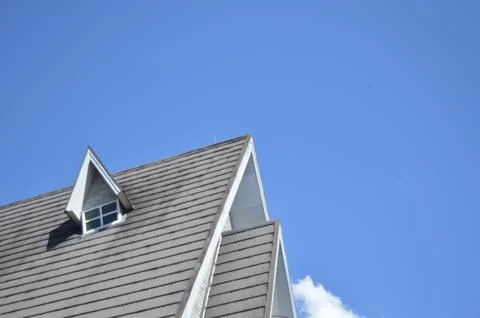 Beautiful triangular roof with a small window Stock Photos