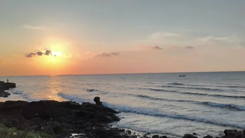 Beautiful Tropical Sunset over Ocean Waves and Rocky Coastline Stock Footage 340489665