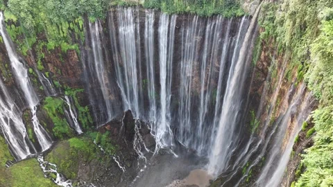 Beautiful tropical waterfall surrounded by lush rainforest viewed from drone Stock Footage 340106555