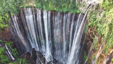 Beautiful tropical waterfall surrounded by lush rainforest viewed from drone Stock Footage 340106564