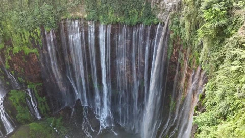 Beautiful tropical waterfall surrounded by lush rainforest viewed from drone Stock Footage 340106566