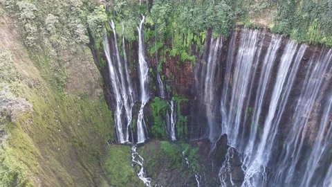 Beautiful tropical waterfall surrounded by lush rainforest viewed from drone Stock Footage 340106568
