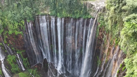 Beautiful tropical waterfall surrounded by lush rainforest viewed from drone Stock Footage 340106572