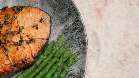 Beautiful trout lying on a plate decorated with asparagus. Stock Footage 158242453