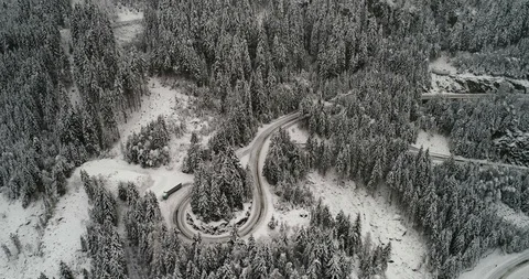 Beautiful twisting mountain road covered in snow in winter time. Stock Footage 102425236