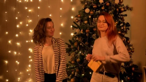  Beautiful two girls dancing on the background of  a Christmas tree. Dancing  Stock Footage 120133408