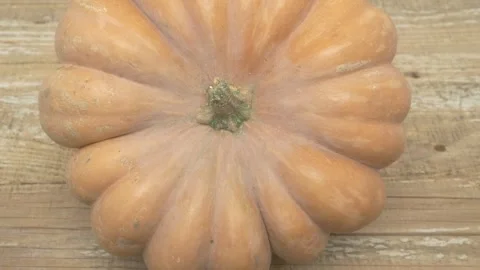 A Beautiful, Unique Pumpkin Set Against a Rustic Wooden Background That Stock Footage 285317407