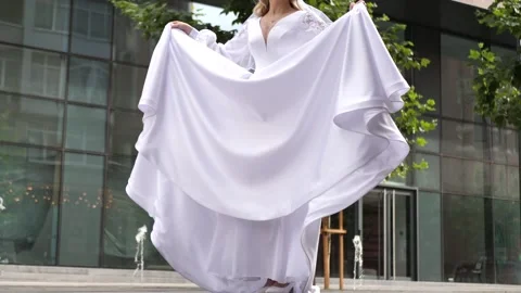 Beautiful unrecognizable bride slowly lowered her wedding dress. slow motion Stock Footage 217545147