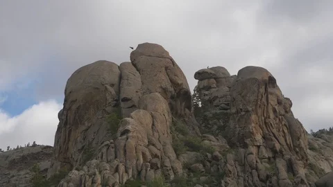 Beautiful unusual rocks with an eagle soaring above them Stock Footage 126366724