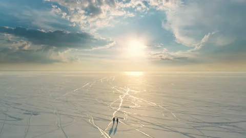 The beautiful upper view on the snow field and walking expeditors Video stock 189399867