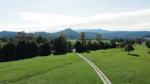 A beautiful valley with a river winding through lush fields and forests. Video stock 287114265