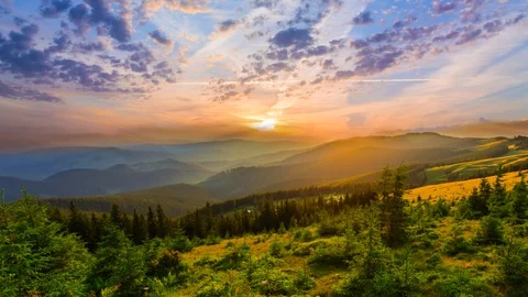 Beautiful varicoloured dramatic sunset over a mountain valley time lapse scene Stock Footage 101419800