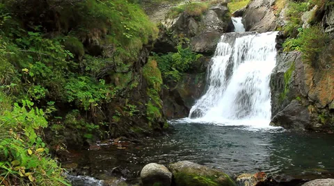 Beautiful veil cascading waterfall, mossy rocks Stock Footage 31848351