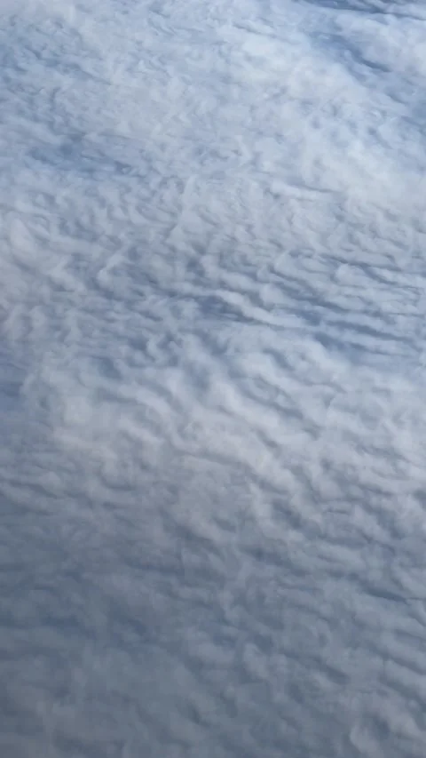Beautiful veil of clouds under the wing of an airplane Stock Footage 237761779