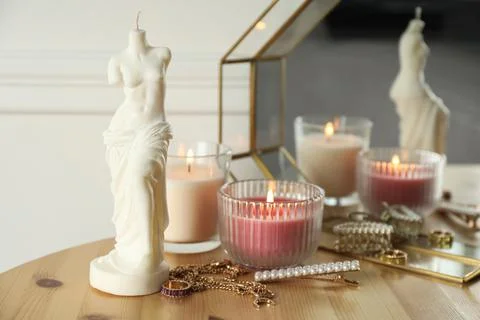 Beautiful Venus De Milo candle on wooden table. Stylish decor Stock Photos