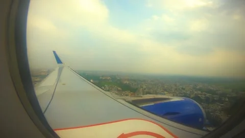 Beautiful view of airplane window overlooking city of India Stock Footage 293411495