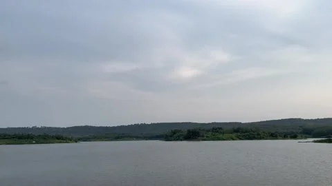 Beautiful view of artificial lake in the middle of green rice fields and hills Stock Footage 307613492