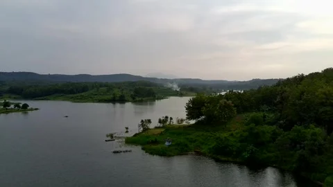 Beautiful view of artificial lake in the middle of green rice fields and hills Video stock 307625811