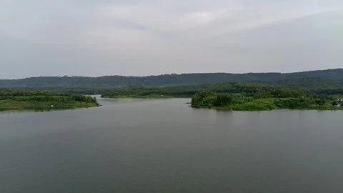 Beautiful view of artificial lake in the middle of green rice fields and hills Stock Footage 307625830