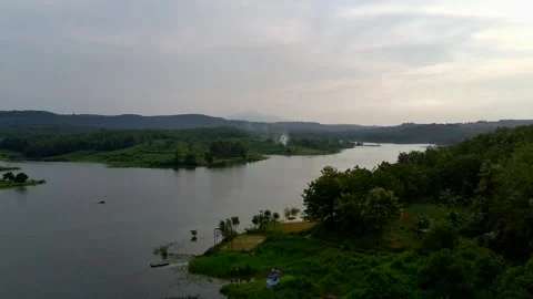 Beautiful view of artificial lake in the middle of green rice fields and hills Stock Footage 307625834