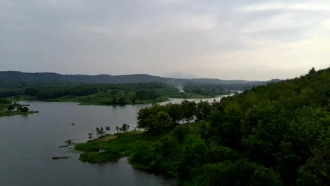 Beautiful view of artificial lake in the middle of green rice fields and hills Stock Footage 307625955