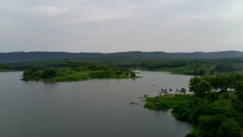 Beautiful view of artificial lake in the middle of green rice fields and hills Stock Footage 307625963