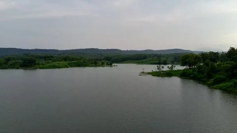 Beautiful view of artificial lake in the middle of green rice fields and hills Stock Footage 307625968