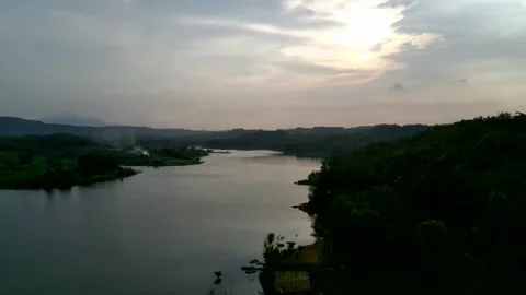 Beautiful view of artificial lake in the middle of green rice fields and hills Stock Footage 307626147