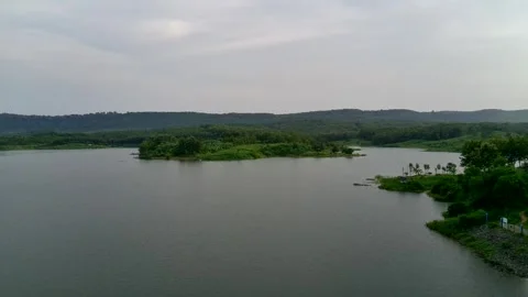 Beautiful view of artificial lake in the middle of green rice fields and hills Video stock 307626156