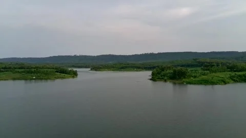 Beautiful view of artificial lake in the middle of green rice fields and hills Stock Footage 307626208
