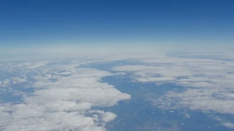 Beautiful view of the blue sky with clouds from the porthole of the plane during Stock-Footage 79983905