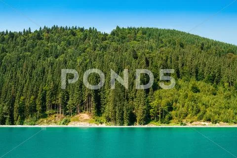 Beautiful view of boat in lake, forest and mountains Stock Photos