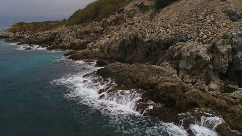 Beautiful view of the breaking waves into moutains with people in Turkey. Stormy Stock Footage 86677871
