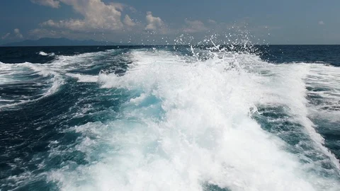 Beautiful view of the bubbling and splashing sea water and foam in blue sea Stock Footage 89209716