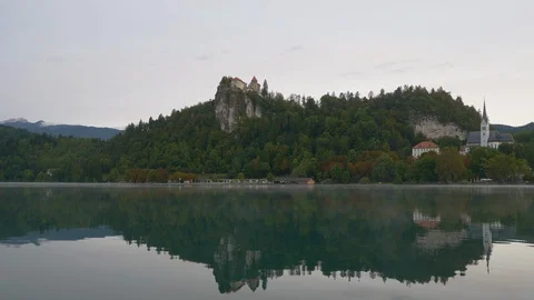 Beautiful view at the Castle of Bled and Church of Saint Martin near Lake of Stock Footage 129541399