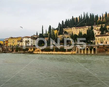 Beautiful view of Castle San Pietro (St.Peter's Castle), Adige river and city Stock Photos